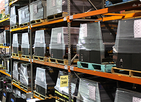 Warehouse: stacked machines ready to ship